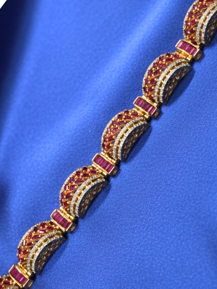 Close-up of an ornate Indo-western American Diamond Pink Bracelet with Gold Polish, Pink Colored Stones, American Diamond and filigree Work. Reception-ready look featuring a statement American diamond Bracelet. Close-up of a cocktail party look featuring a premium American diamond Bracelet.