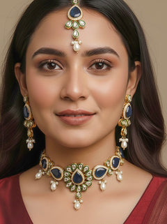 Close-up of a women wearing an ornate traditional Navy Blue Choker jewellery set and earrings and maangtikka with Kundan, Monalisa Stone, American Diamonds, Beads and Reverse American Diamonds and tumble stones. A graceful woman wearing a trending Colored Stone necklace for a 2026 wedding celebration. Elegant wedding jewelry look featuring a premium artificial Colored Stone necklace.