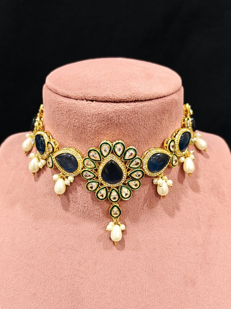 Close-up of an ornate traditional Navy Blue Choker jewellery set and earrings and maangtikka with Kundan, Monalisa Stone, American Diamonds, Beads and Reverse American Diamonds and tumble stones. A graceful woman wearing a trending Colored Stone necklace for a 2026 wedding celebration. Elegant wedding jewelry look featuring a premium artificial Colored Stone necklace.