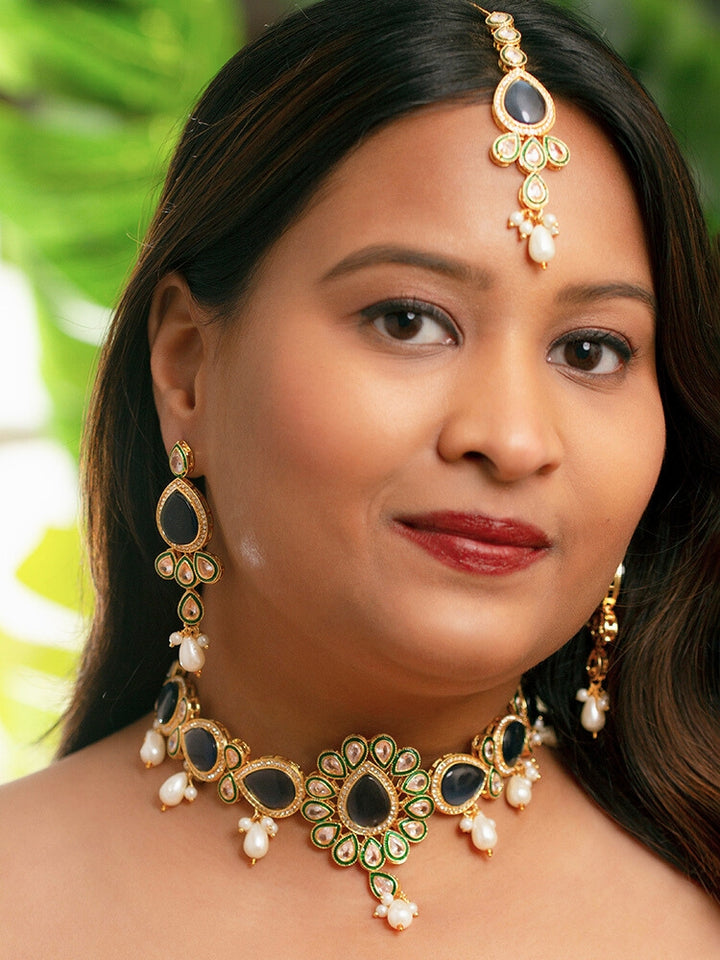 Close-up of a women wearing an ornate traditional Navy Blue Choker jewellery set and earrings and maangtikka with Kundan, Monalisa Stone, American Diamonds, Beads and Reverse American Diamonds and tumble stones. A graceful woman wearing a trending Colored Stone necklace for a 2026 wedding celebration. Elegant wedding jewelry look featuring a premium artificial Colored Stone necklace.
