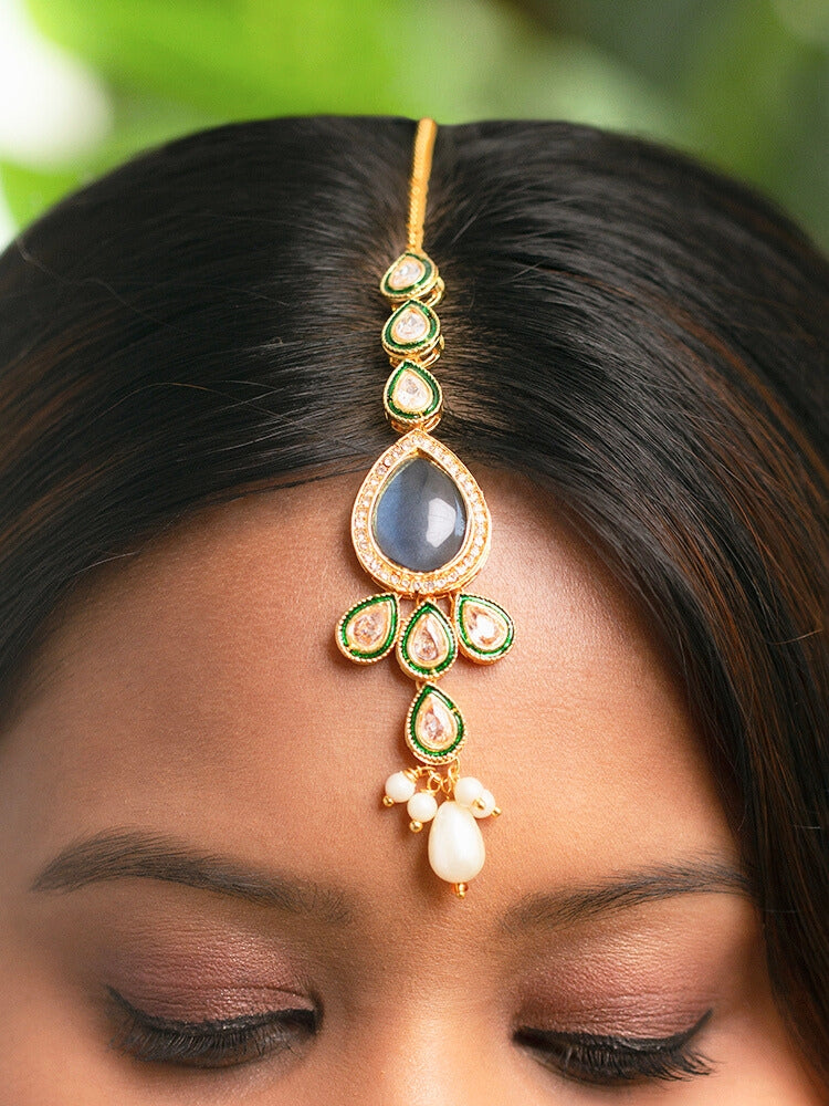 Close-up of a women wearing an ornate traditional Navy Blue Choker jewellery set and earrings and maangtikka with Kundan, Monalisa Stone, American Diamonds, Beads and Reverse American Diamonds and tumble stones. A graceful woman wearing a trending Colored Stone necklace for a 2026 wedding celebration. Elegant wedding jewelry look featuring a premium artificial Colored Stone necklace.