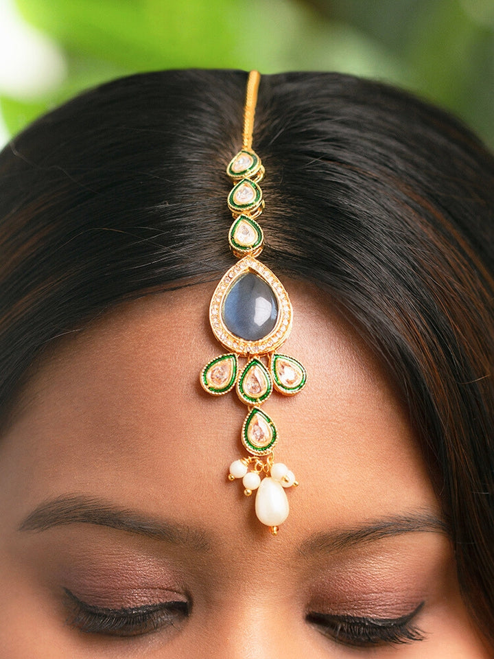 Close-up of a women wearing an ornate traditional Navy Blue Choker jewellery set and earrings and maangtikka with Kundan, Monalisa Stone, American Diamonds, Beads and Reverse American Diamonds and tumble stones. A graceful woman wearing a trending Colored Stone necklace for a 2026 wedding celebration. Elegant wedding jewelry look featuring a premium artificial Colored Stone necklace.