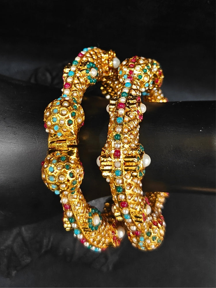 Close-up of an ornate traditional (Gold Polish) Bracelet with Colored Stones. Mehendi ceremony look completed with a Colored stone Bracelet. 