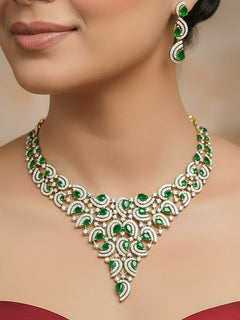 Close-up of a woman wearing an ornate Indo-Western Green Diamond gold Collar jewellery set and earrings with American Diamond and Green Colored Stones. Close-up of a cocktail party look featuring a premium American diamond necklace. Mehendi function outfit styled with a lightweight American Diamond necklace.