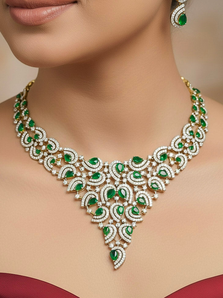 Close-up of a woman wearing an ornate Indo-Western Green Diamond gold Collar jewellery set and earrings with American Diamond and Green Colored Stones. Close-up of a cocktail party look featuring a premium American diamond necklace. Mehendi function outfit styled with a lightweight American Diamond necklace.