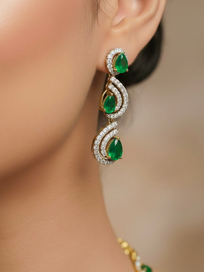 Close-up of a woman wearing an ornate Indo-Western Green Diamond gold Collar jewellery set and earrings with American Diamond and Green Colored Stones. Close-up of a cocktail party look featuring a premium American diamond necklace. Mehendi function outfit styled with a lightweight American Diamond necklace.