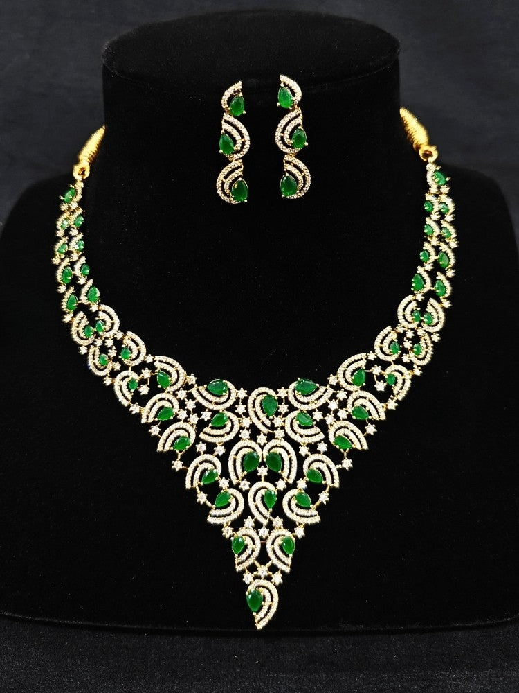 Close-up of a woman wearing an ornate Indo-Western Green Diamond gold Collar jewellery set and earrings with American Diamond and Green Colored Stones. Close-up of a cocktail party look featuring a premium American diamond necklace. Mehendi function outfit styled with a lightweight American Diamond necklace.
