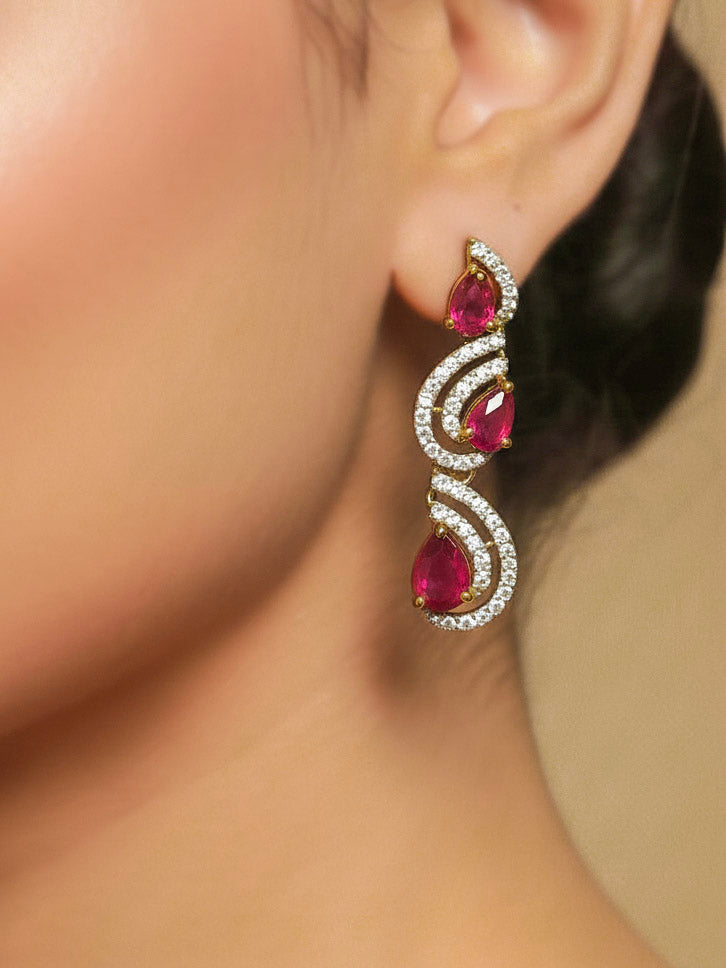 Close-up of a woman wearing an ornate Indo-Western Red Diamond gold Collar jewellery set and earrings with American Diamond and Red Colored Stones. Close-up of a cocktail party look featuring a premium American diamond necklace. Mehendi function outfit styled with a lightweight American Diamond necklace.
