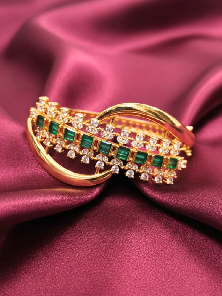 Close-up of an ornate Indo-western Green (Bright gold) Diamond Bracelet with American Diamond and Colored Stones. A sparkling American diamond artificial bracelet for a party. Close-up of an anti-tarnish artificial American Diamond bracelet styled for wedding guests.