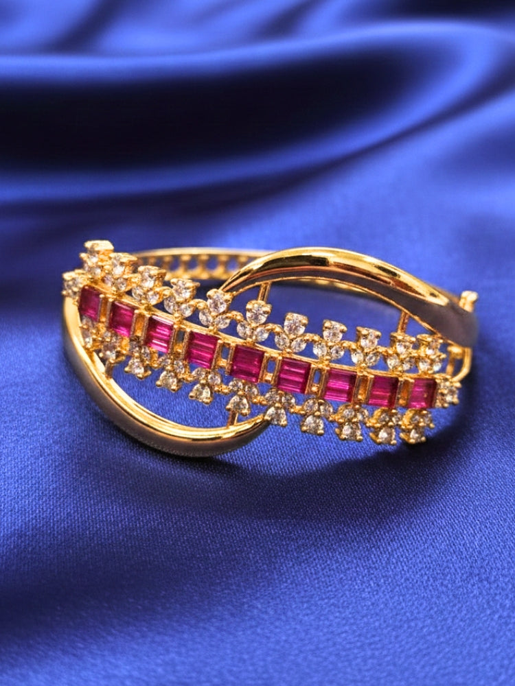 Close-up of an ornate Indo-western Pink (Bright gold) Diamond Bracelet with American Diamond and Colored Stones. A sparkling American diamond artificial bracelet for a party. Close-up of an anti-tarnish artificial American Diamond bracelet styled for wedding guests.