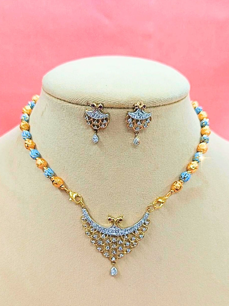 Niharika Mangalsutra—a gold necklace with black mangalsutra beads and matching earrings, pendant featuring sparkling American Diamonds—set against a cream dummy, perfect for your wedding ceremony dress. Diamond mangalsutra. Modern mangalsutra. 