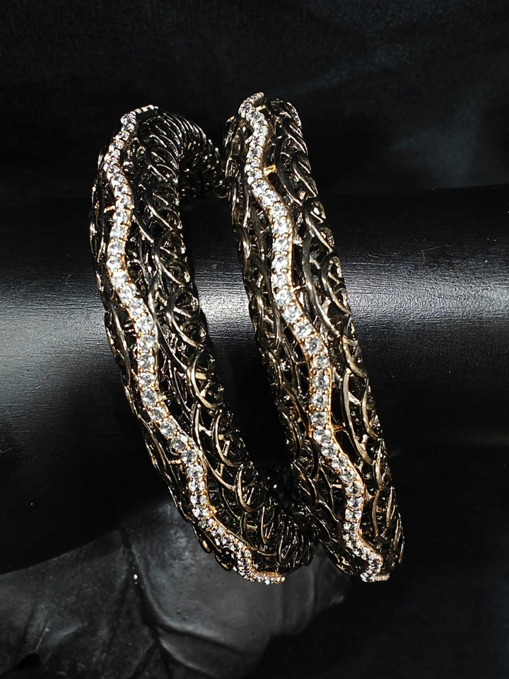 Close-up of an ornate Indo-western (Black Polish) Bangles with American Diamond. Wedding guest styling elegant artificial American Diamond bangles in India. Close-up of sparkling artificial American Diamond bangles for party wear. Luxury artificial American Diamond bangles styled for a wedding function.