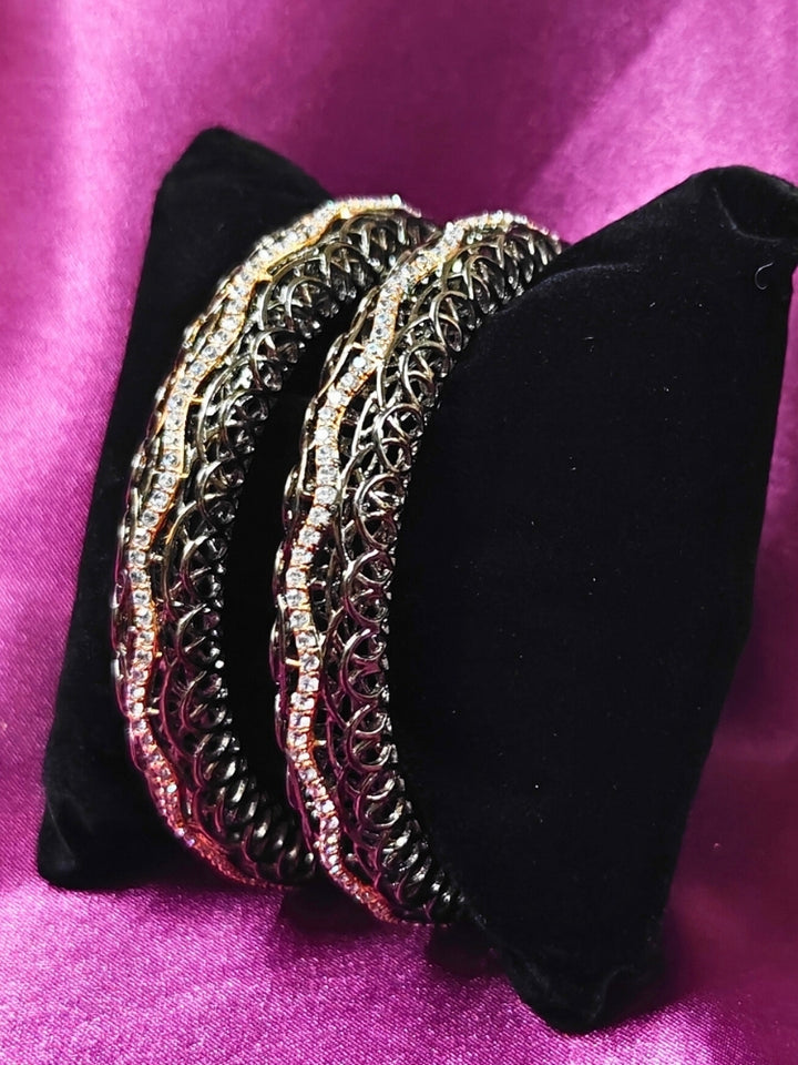 Close-up of an ornate Indo-western (Black Polish) Bangles with American Diamond. Wedding guest styling elegant artificial American Diamond bangles in India. Close-up of sparkling artificial American Diamond bangles for party wear. Luxury artificial American Diamond bangles styled for a wedding function.