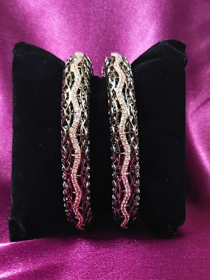 Close-up of an ornate Indo-western (Black Polish) Bangles with American Diamond. Wedding guest styling elegant artificial American Diamond bangles in India. Close-up of sparkling artificial American Diamond bangles for party wear. Luxury artificial American Diamond bangles styled for a wedding function.