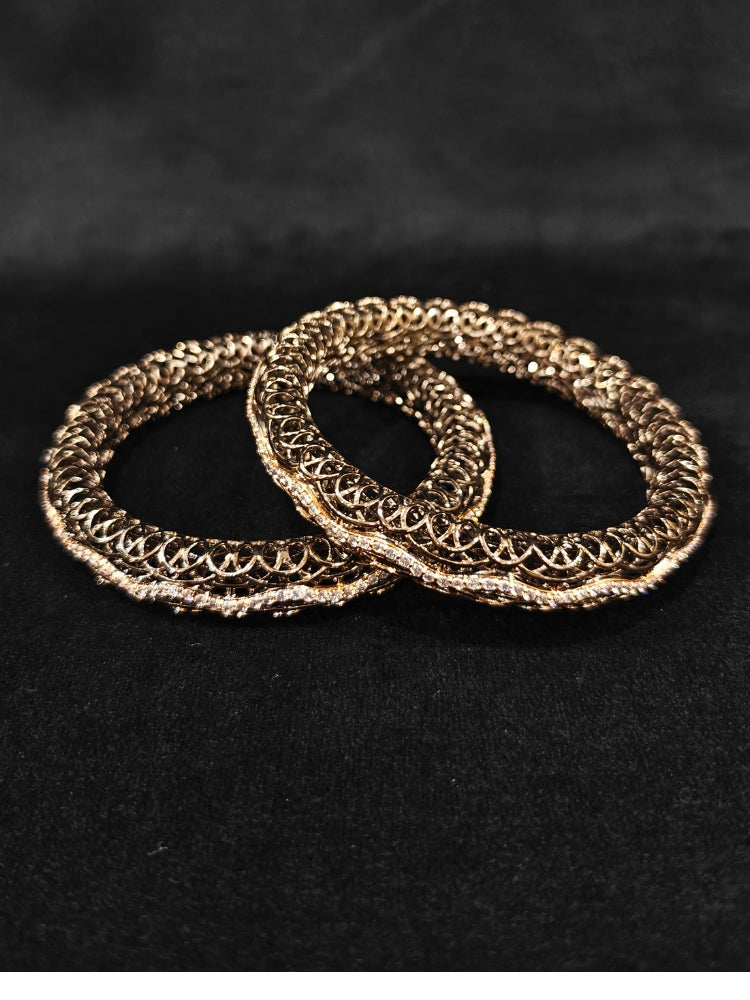 Close-up of an ornate Indo-western (Black Polish) Bangles with American Diamond. Wedding guest styling elegant artificial American Diamond bangles in India. Close-up of sparkling artificial American Diamond bangles for party wear. Luxury artificial American Diamond bangles styled for a wedding function.