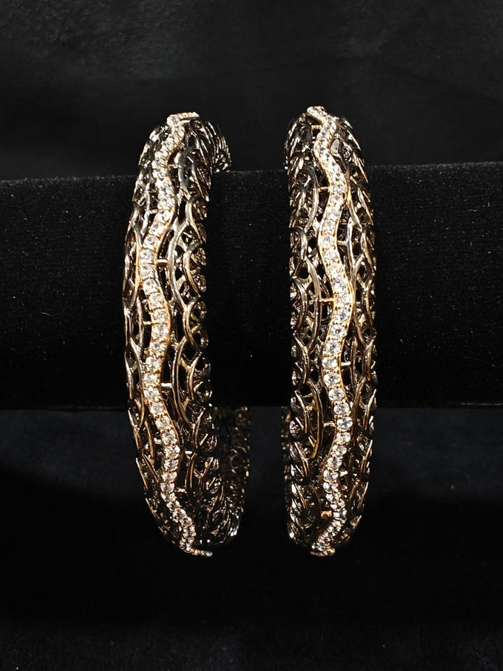 Close-up of an ornate Indo-western (Black Polish) Bangles with American Diamond. Wedding guest styling elegant artificial American Diamond bangles in India. Close-up of sparkling artificial American Diamond bangles for party wear. Luxury artificial American Diamond bangles styled for a wedding function.