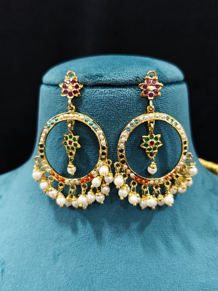 Close-up of an ornate handmade jadau jewelry set and earrings with multicolor jadau gemstones. This is a perfect long jadau jewelry set for weddings, festivals and more. Can also be worn as bridal long jadau jewelry for indian weddings. 