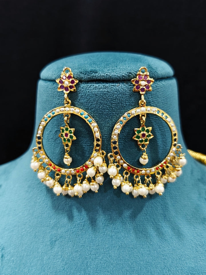 Close-up of an ornate handmade jadau jewelry set and earrings with multicolor jadau gemstones. This is a perfect long jadau jewelry set for weddings, festivals and more. Can also be worn as bridal long jadau jewelry for indian weddings. 