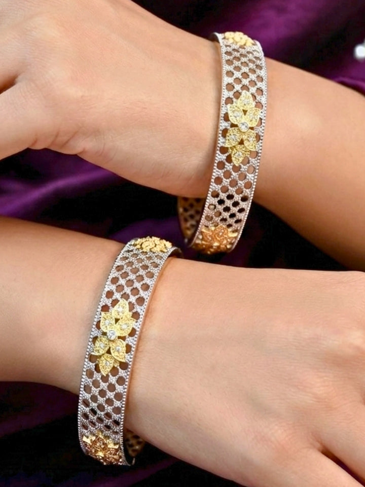 Close-up of a woman wearing an ornate Indo-Western (Silver Polish) Bangles Set with American Diamond. Woman wearing anti-tarnish artificial American Diamond bangles for long functions. Wedding guest styling elegant artificial American Diamond bangles in India.