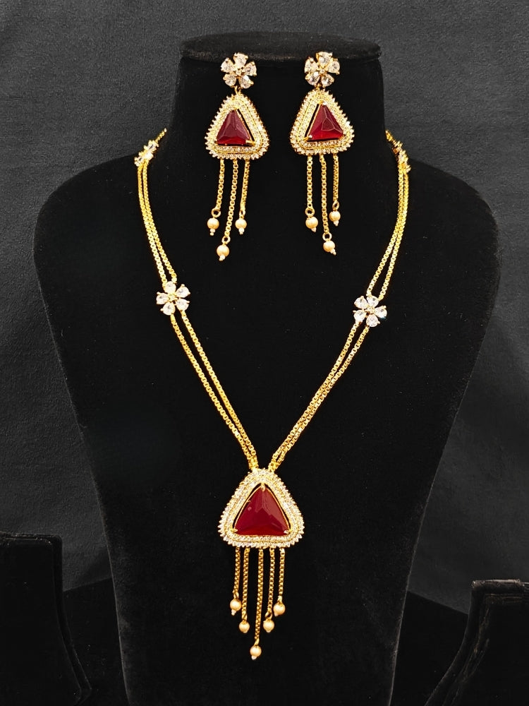 An elegant artificial diamond necklace with red colored stone and matching earrings. This premium artificial diamond jewelry set is perfect for special occasions, from Indian weddings to engagement parties, offering sophisticated glamour without the high price tag.