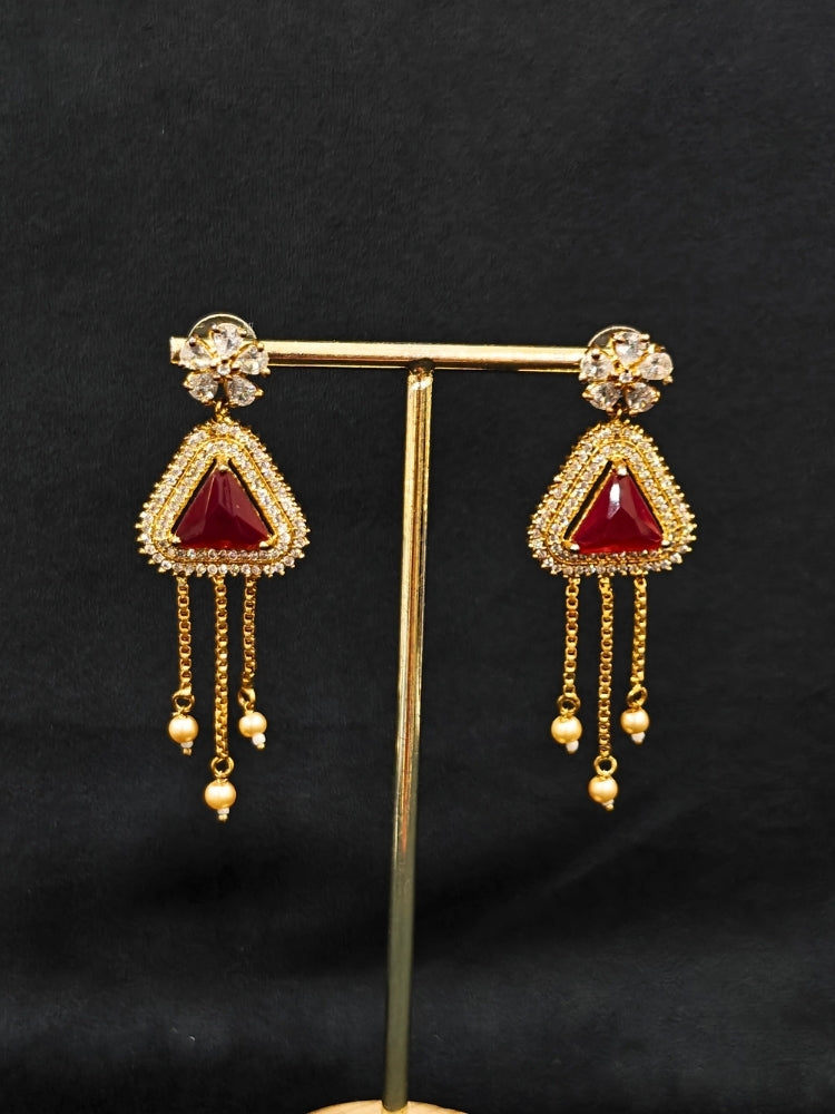 An elegant artificial diamond necklace with red colored stone and matching earrings. This premium artificial diamond jewelry set is perfect for special occasions, from Indian weddings to engagement parties, offering sophisticated glamour without the high price tag.