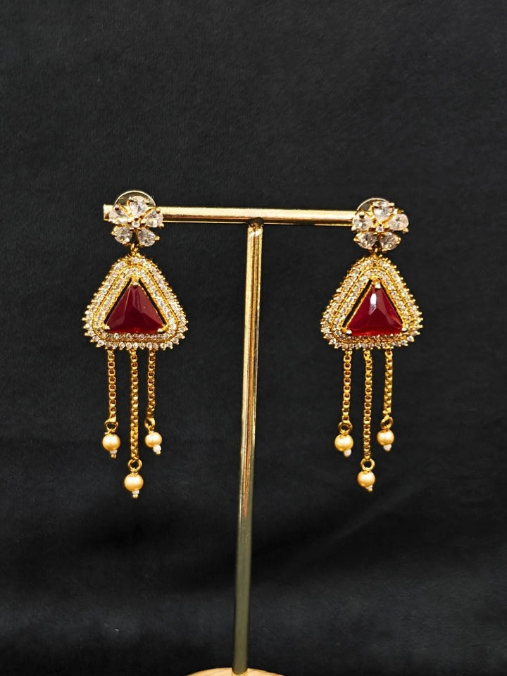 An elegant artificial diamond necklace with red colored stone and matching earrings. This premium artificial diamond jewelry set is perfect for special occasions, from Indian weddings to engagement parties, offering sophisticated glamour without the high price tag.