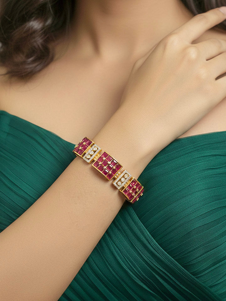 Close-up of a woman wearing an ornate Indo-western American Diamond Pink Bracelet with Pink Colored Stones, American Diamond and filligree Work. Reception-ready look featuring a statement American diamond Bracelet. Close-up of a cocktail party look featuring a premium American diamond Bracelet.