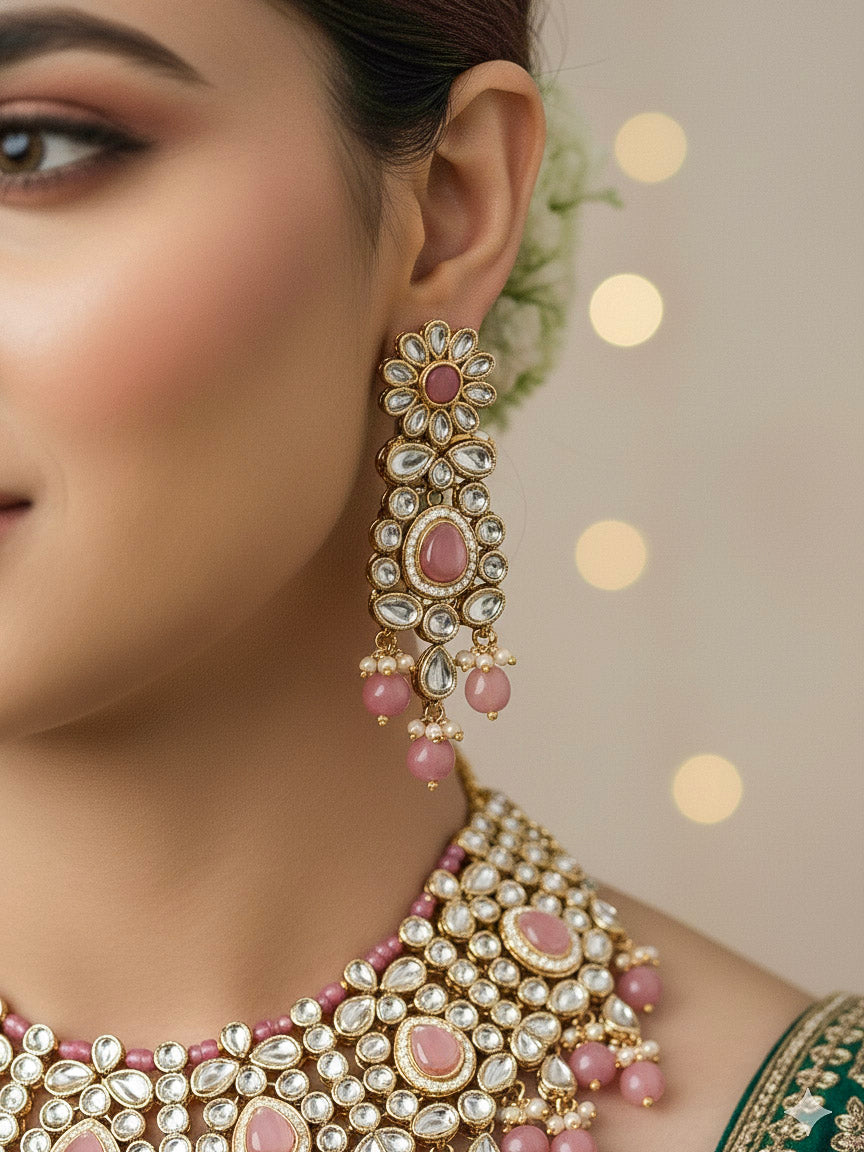 Close-up of a woman wearing an ornate traditional Pink Collar jewellery set and earrings and maangtikka with Kundan, Beads and Pearls. Royal bridal look featuring a traditional Kundan necklace set. Woman wearing trending Kundan artificial jewelry for wedding season in India. Close-up of intricate Kundan craftsmanship in artificial bridal jewelry.