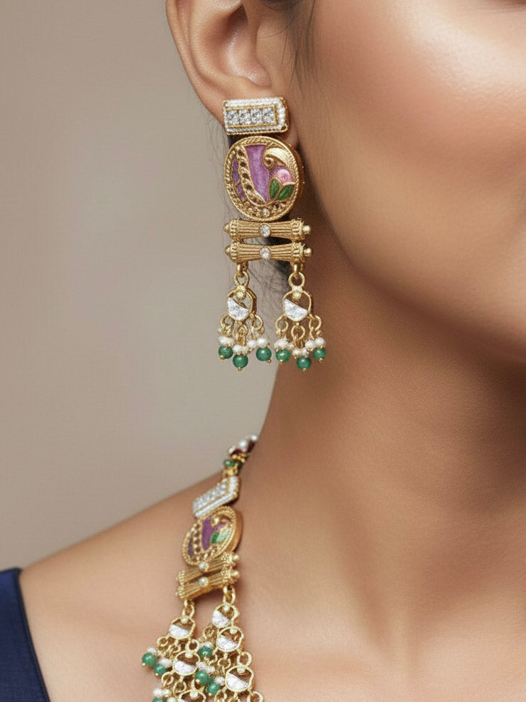 Close-up of a woman wearing an ornate traditional Mint Pink and Green Heritage gold Long Layered jewellery set and earrings with Colored Stones and Beads. Festive celebration outfit paired with a handcrafted heritage jewelry set. Festive  outfit styled with a royal heritage necklace. Festive celebration look enhanced with traditional Meenakari jewelry.