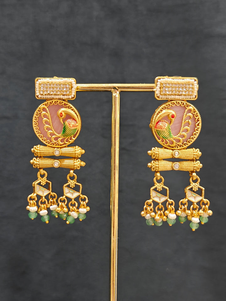 Close-up of an ornate traditional Mint Pink and Green Heritage gold Long Layered jewellery set and earrings with Colored Stones and Beads. Festive celebration outfit paired with a handcrafted heritage jewelry set. Festive  outfit styled with a royal heritage necklace. Festive celebration look enhanced with traditional Meenakari jewelry.