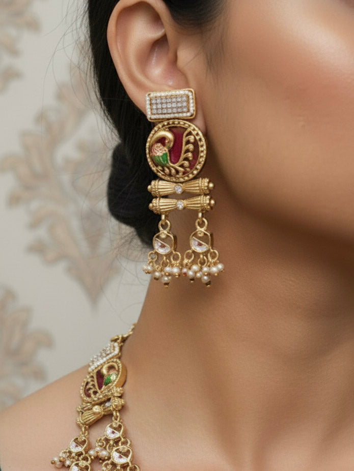 Close-up of a woman wearing an ornate traditional Dark Pink Heritage gold Long Layered jewellery set and earrings with Colored Stones and Beads. Festive celebration outfit paired with a handcrafted heritage jewelry set. Festive  outfit styled with a royal heritage necklace.