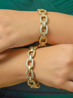 Close-up of a woman wearing an ornate Indo-western White Diamond (Mehendi Polish) Bangles with American Diamond. Close-up shot of a high-quality American diamond artificial Bangles worn for festive celebrations. Wedding guest styling elegant artificial American Diamond bangles in India.