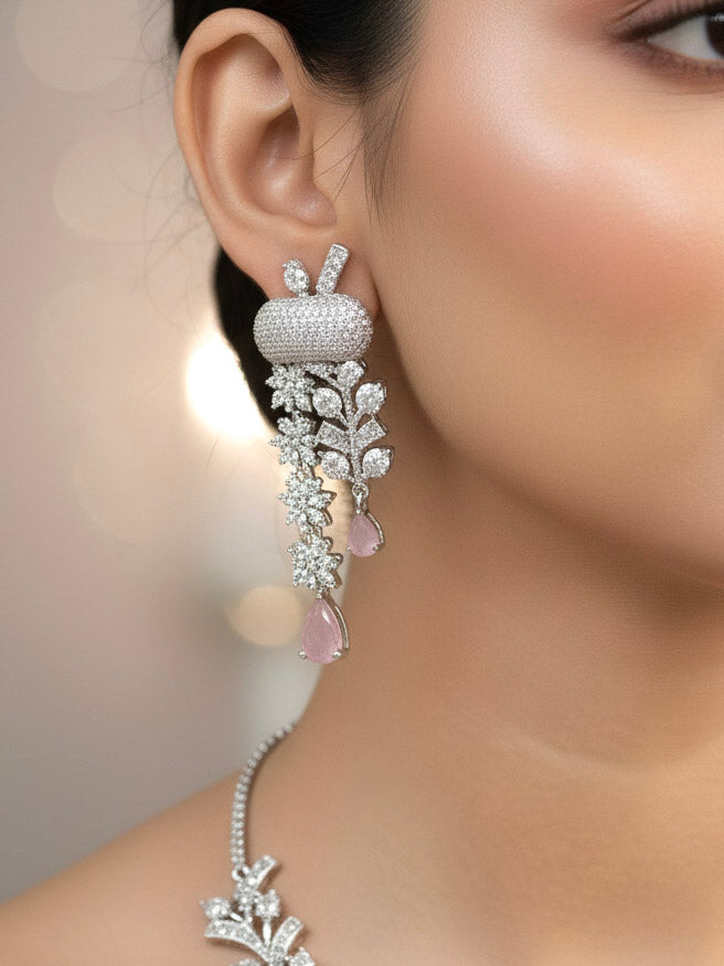 "A stunning woman wearing a glamorous artificial diamond and mint pink colored stone necklace paired with chic earrings, perfect for bridal wear. This high-quality artificial diamond jewelry set is the ideal choice for modern brides looking for a budget-friendly option with timeless sparkle."
