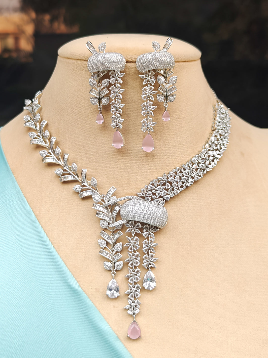 "Close-up of a model in luxurious artificial diamond jewelry featuring a designer diamond and mint pink colored stone necklace and earrings set, crafted for bridal fashion and high-end weddings. This beautiful diamond jewelry set offers the brilliance of real diamonds at an affordable price."