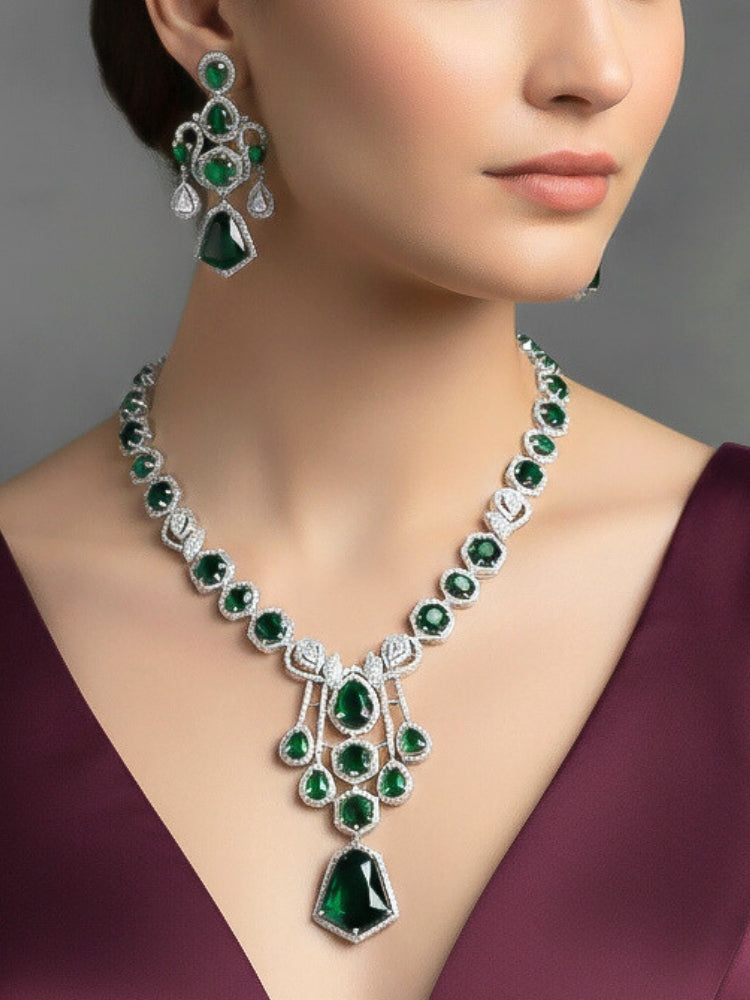 "A bride-to-be wearing an exquisite artificial diamond and green colored stone necklace and matching earrings, designed for the perfect engagement look. This stunning artificial diamond jewelry set offers luxury and sophistication while being an affordable alternative to natural diamonds."