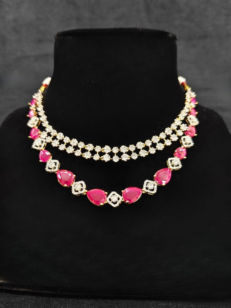 A glamorous artificial diamond and pink colored stone necklace paired with chic earrings, perfect for bridal wear. This high-quality artificial diamond jewelry set is the ideal choice for modern brides looking for a budget-friendly option with timeless sparkle.