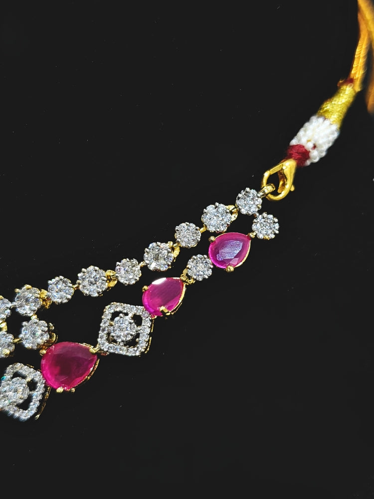 A glamorous artificial diamond and pink colored stone necklace paired with chic earrings, perfect for bridal wear. This high-quality artificial diamond jewelry set is the ideal choice for modern brides looking for a budget-friendly option with timeless sparkle.