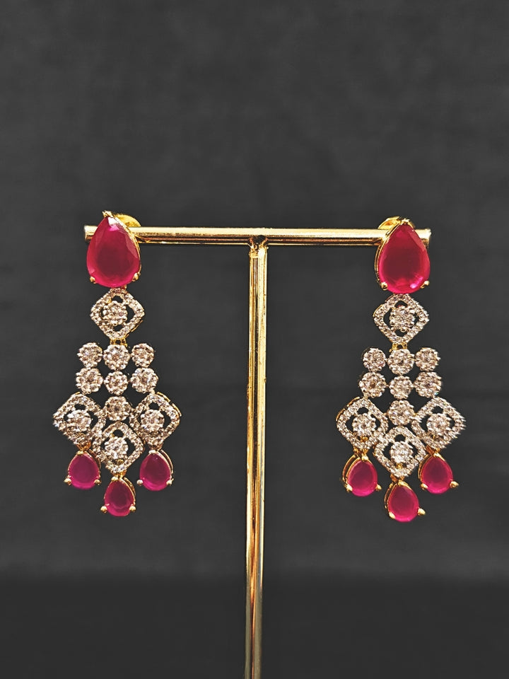 A glamorous artificial diamond and pink colored stone necklace paired with chic earrings, perfect for bridal wear. This high-quality artificial diamond jewelry set is the ideal choice for modern brides looking for a budget-friendly option with timeless sparkle.