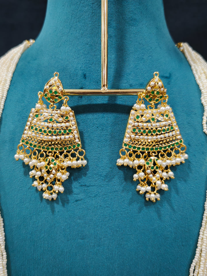 Close-up of high-quality long Jadau artificial necklace with matched Earring craftsmanship. a royal Jadau necklace for festive events in India and traditional Indian wedding. elegant green Jadau long necklace, adorned with delicate pearls and intricate detailing, adds a royal charm to any traditional look.

