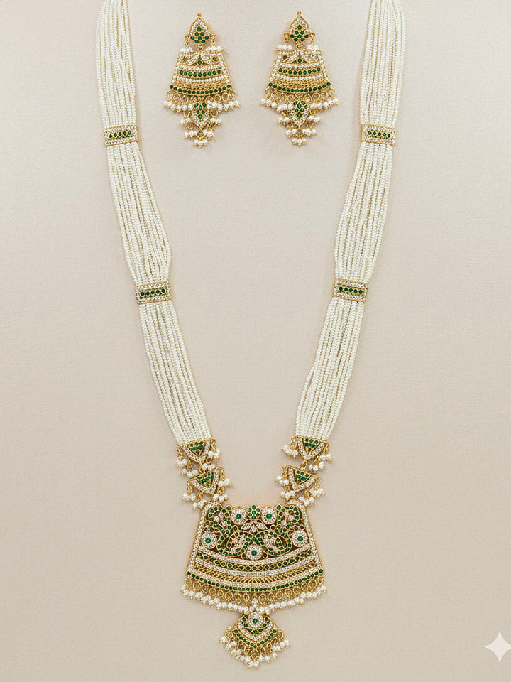 Close-up of a woman wearing an ornate handmade long jadau jewelry set and earrings with jadau gemstones. This is a perfect jadau jewelry set for weddings, festivals and more. Can also be worn as bridal jadau jewelry for indian weddings. 