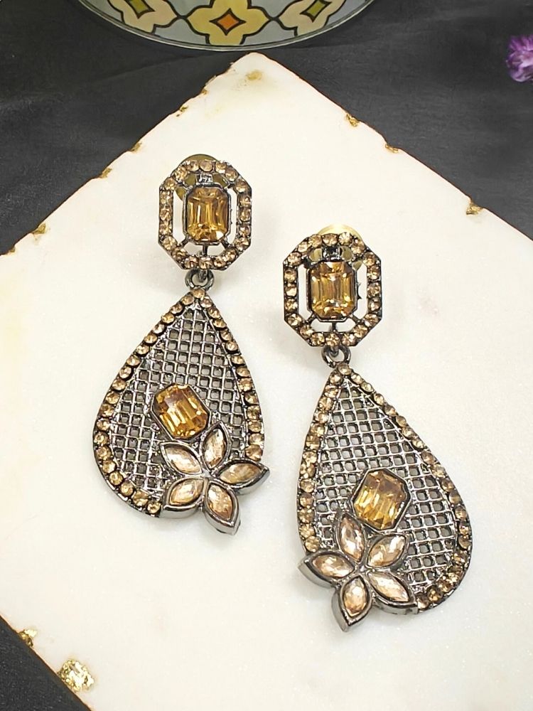 Close-up of an ornate Indo-Western (Black Polish) Champaign Earrings Set with American Diamond. Festive Navratri look styled with premium artificial earrings. Indo-western outfit styled with a artificial American Diamond ring.