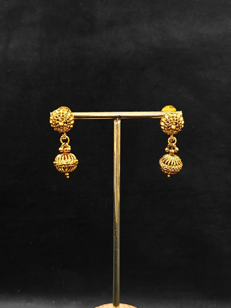 Close-up of an ornate traditional (Bright Gold Polish) Long jewellery set and earrings with Filigree Balls. Woman styling a vibrant Meenakari Filigree necklace with a festive saree. Festive celebration look enhanced with traditional Filigree jewelry.