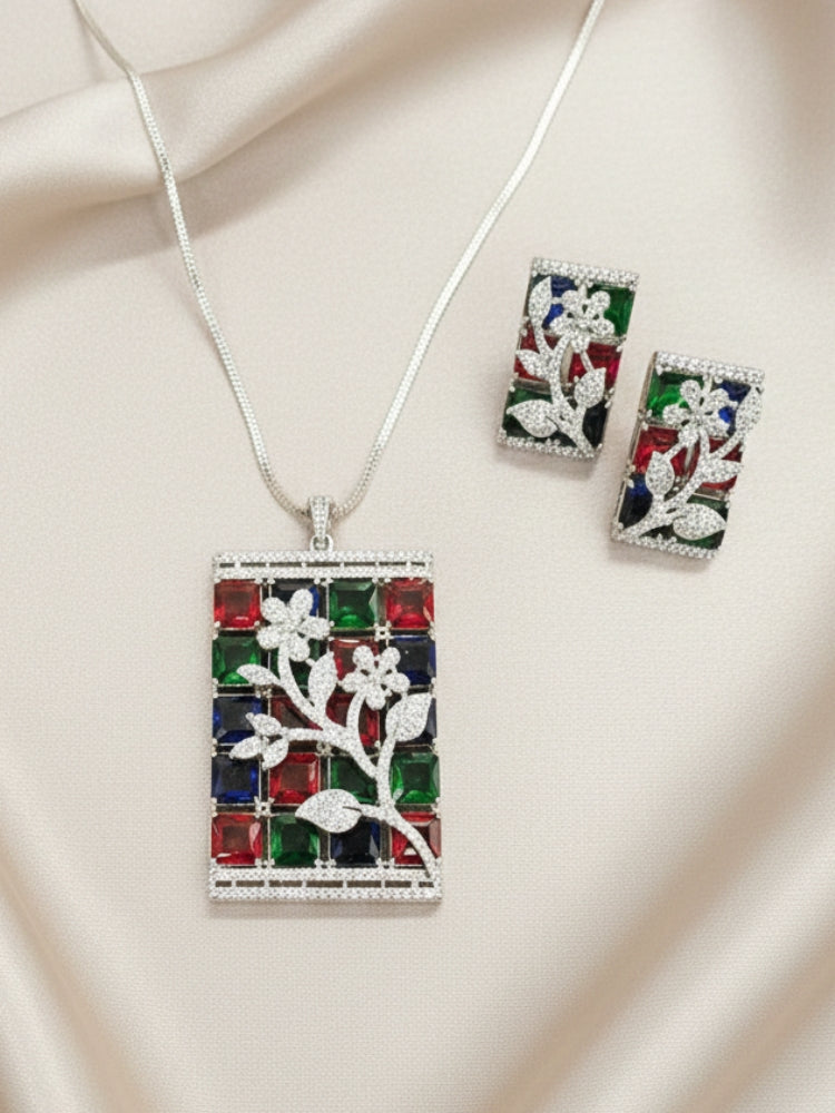 Close-up of an ornate Western (Silver Polish) Colored Stones Pendant set and earrings with American Diamond and Colored Stones. A luxury artificial Colored Stones Pendant Set for Party. Reception-ready look featuring a statement Colored Stones Pendant set.