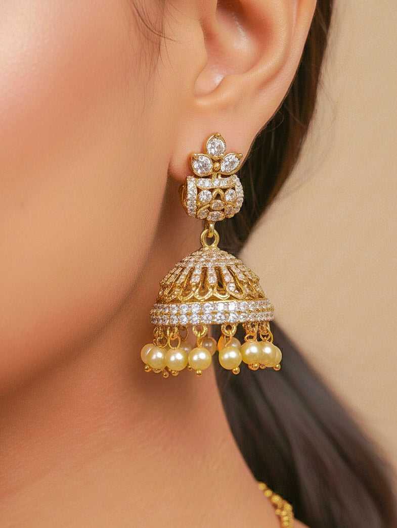 Close-up of a woman wearing an ornate traditional Green Mehendi gold Polish Collar jewellery set and earrings with American Diamond and Green Colored Stones. Mehendi function outfit styled with a lightweight Colored Stone necklace. Festive celebration look featuring a Colored Stone artificial necklace.