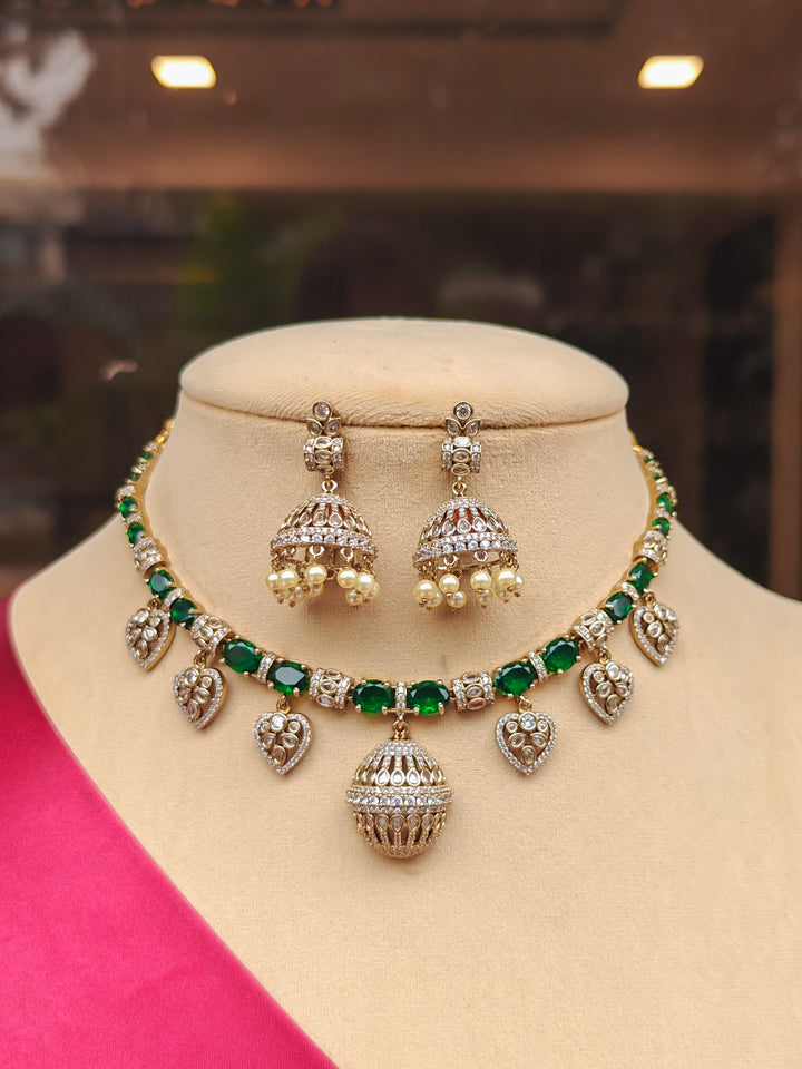 "Elegant woman wearing a luxurious artificial diamond and green colored stone  necklace with jhumki earrings, perfect for high-profile wedding receptions and formal galas. This high-end artificial diamond jewelry set combines style, elegance, and affordability for special occasions."