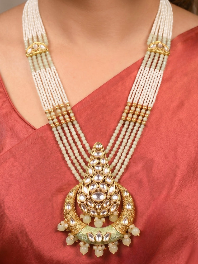 Close-up of a women wearing an ornate traditional (Gold Polish) Mint Green Long jewellery set and earrings with Polki, Crystal Beads, Meenakari and Pearls. Festive Diwali look enhanced with a premium Polki artificial necklace. Saree styling inspiration with a Long Polki imitation jewelry piece.