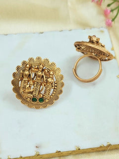 The Pavan Putra Green Ring features a round gold design with intricate carvings of Ram, Laxman and Sitaji, accented by three Green stones—an exquisite ethnic accessory, ideal for wedding and religious ceremonies.