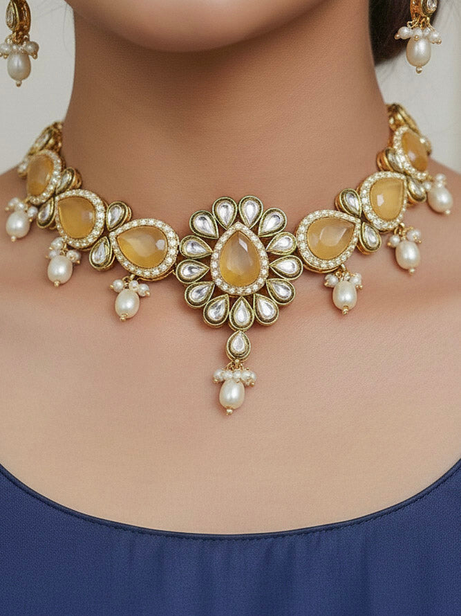 Close-up of a woman wearing an ornate traditional Peach Choker jewellery set and earrings and maangtikka with Kundan, Monalisa Stone, American Diamonds, Beads and Reverse American Diamonds and tumble stones. A graceful woman wearing a trending Colored Stone necklace for a 2026 wedding celebration. Elegant wedding jewelry look featuring a premium artificial Colored Stone necklace.