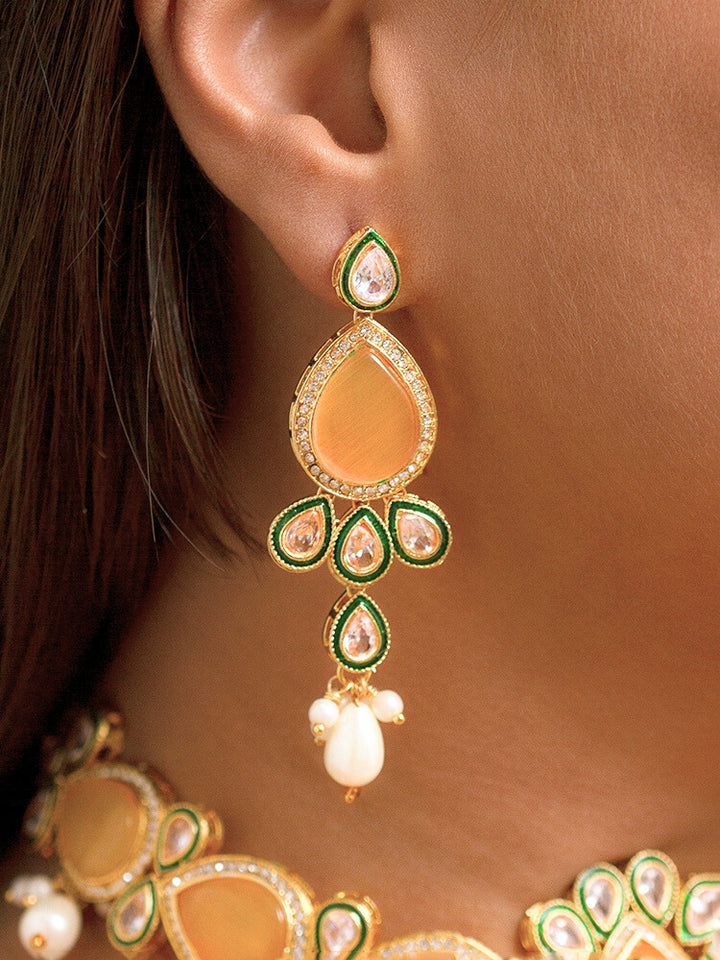 Close-up of a women wearing an ornate traditional Peach Choker jewellery set and earrings and maangtikka with Kundan, Monalisa Stone, American Diamonds, Beads and Reverse American Diamonds and tumble stones. A graceful woman wearing a trending Colored Stone necklace for a 2026 wedding celebration. Elegant wedding jewelry look featuring a premium artificial Colored Stone necklace.