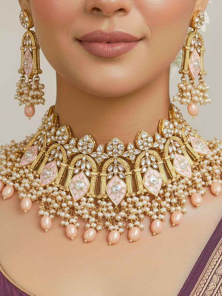 Close-up of a woman wearing an ornate traditional (Gold Polish) Peach Choker jewellery set and earrings and maangtikka with Kundan, Meenakari, Crystal beads and Tumble beads. Close-up of intricate Kundan craftsmanship in artificial bridal jewelry. Bride wearing a traditional Kundan artificial necklace set for her wedding ceremony.